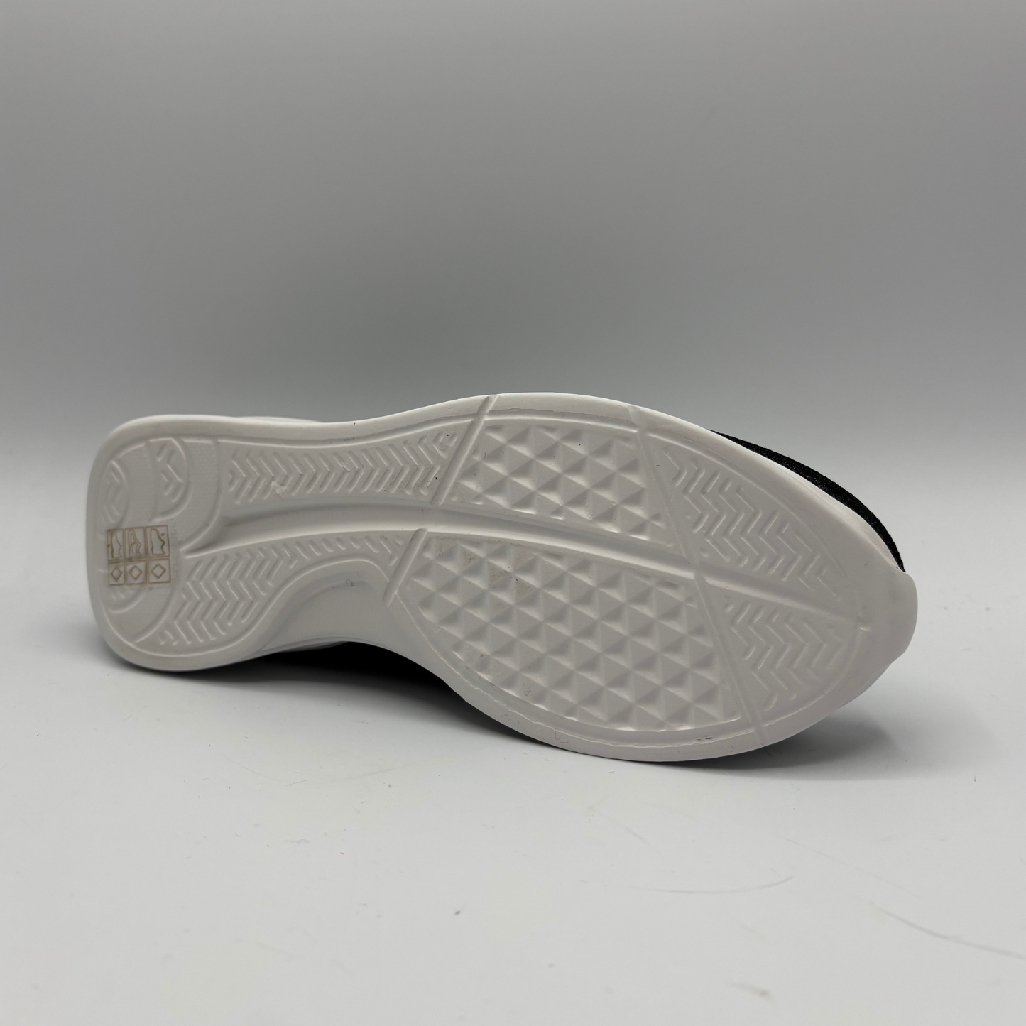 White sole of a shoe on a gray background