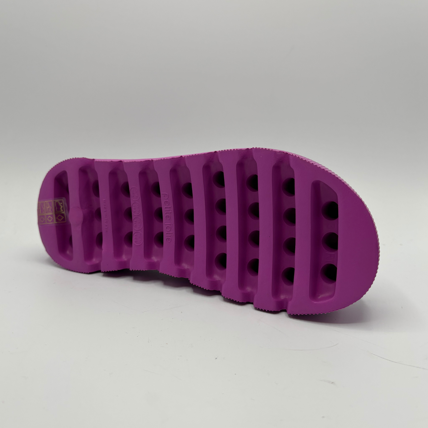 Purple textured shoe sole on a white background