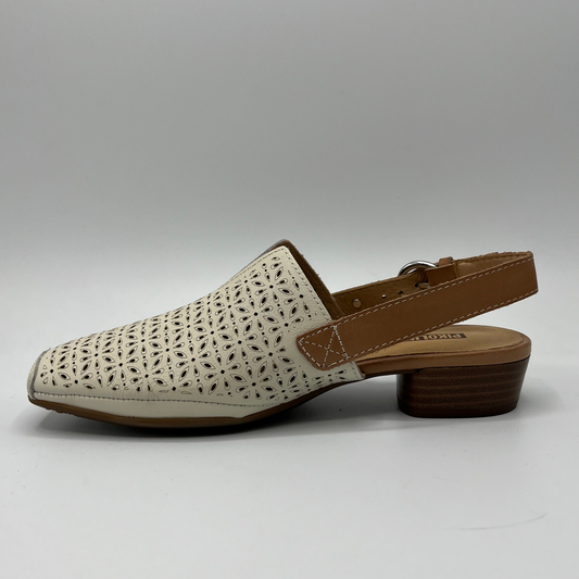 Left facing view of a die cut leather shoe with a short stacked heel and an adjustable slingback strap.