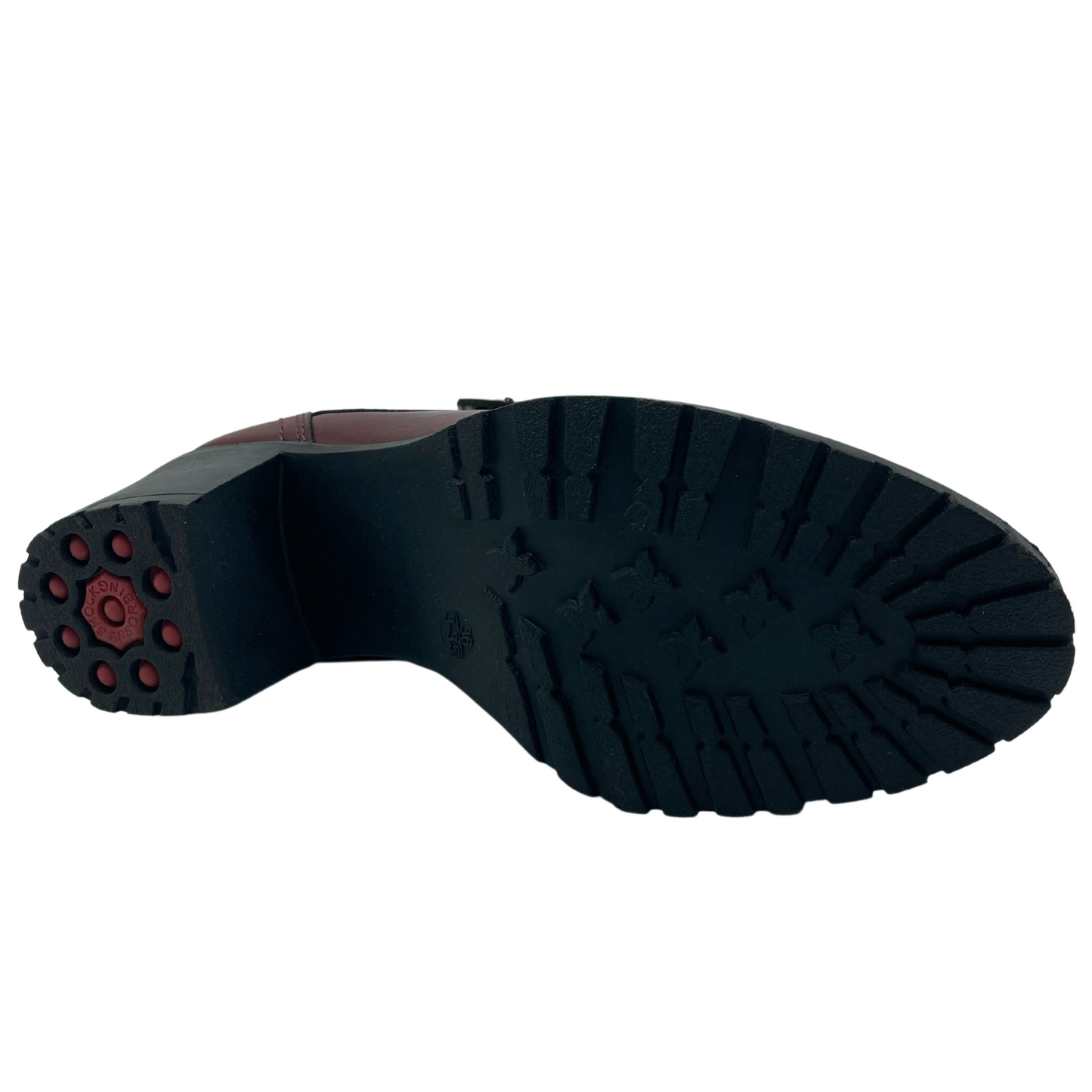Bottom view of black and red rubber sole of faux leather bootie