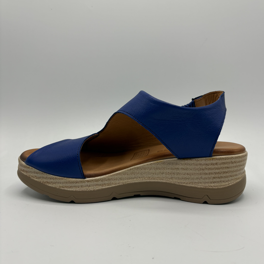 Blue sandal with brown sole on a gray background