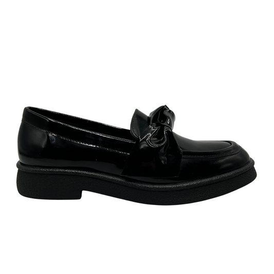 Right facing view of black patent leather loafer with knotted strap detail and black rubber outsole