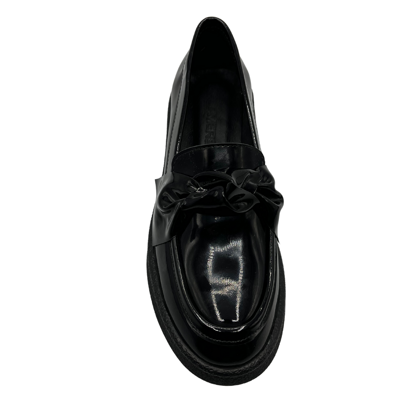 Top view of black patent leather loafer with knotted strap detail and black rubber outsole