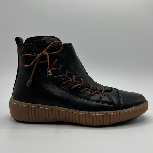 Black ankle boot with brown sole on a gray background