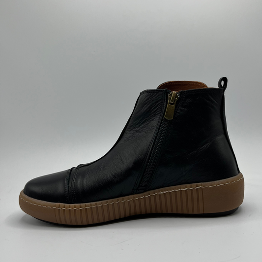 Black leather boot with brown sole on a gray background