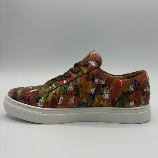 Left facing view of a leather sneaker with a side zip closure and white rubber outsole