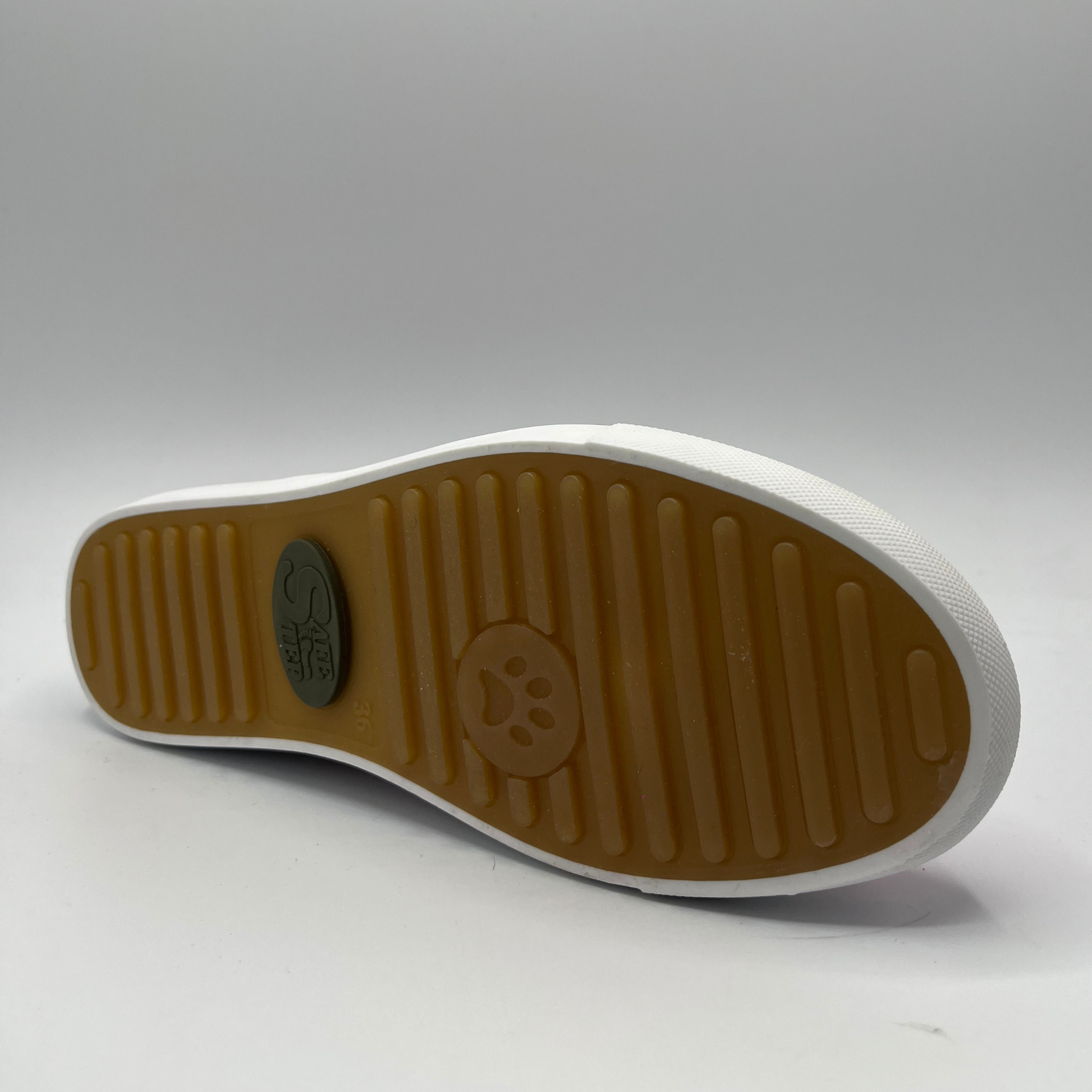Bottom view of a fuschia leather sneaker with elastic laces and a white rubber outsole.