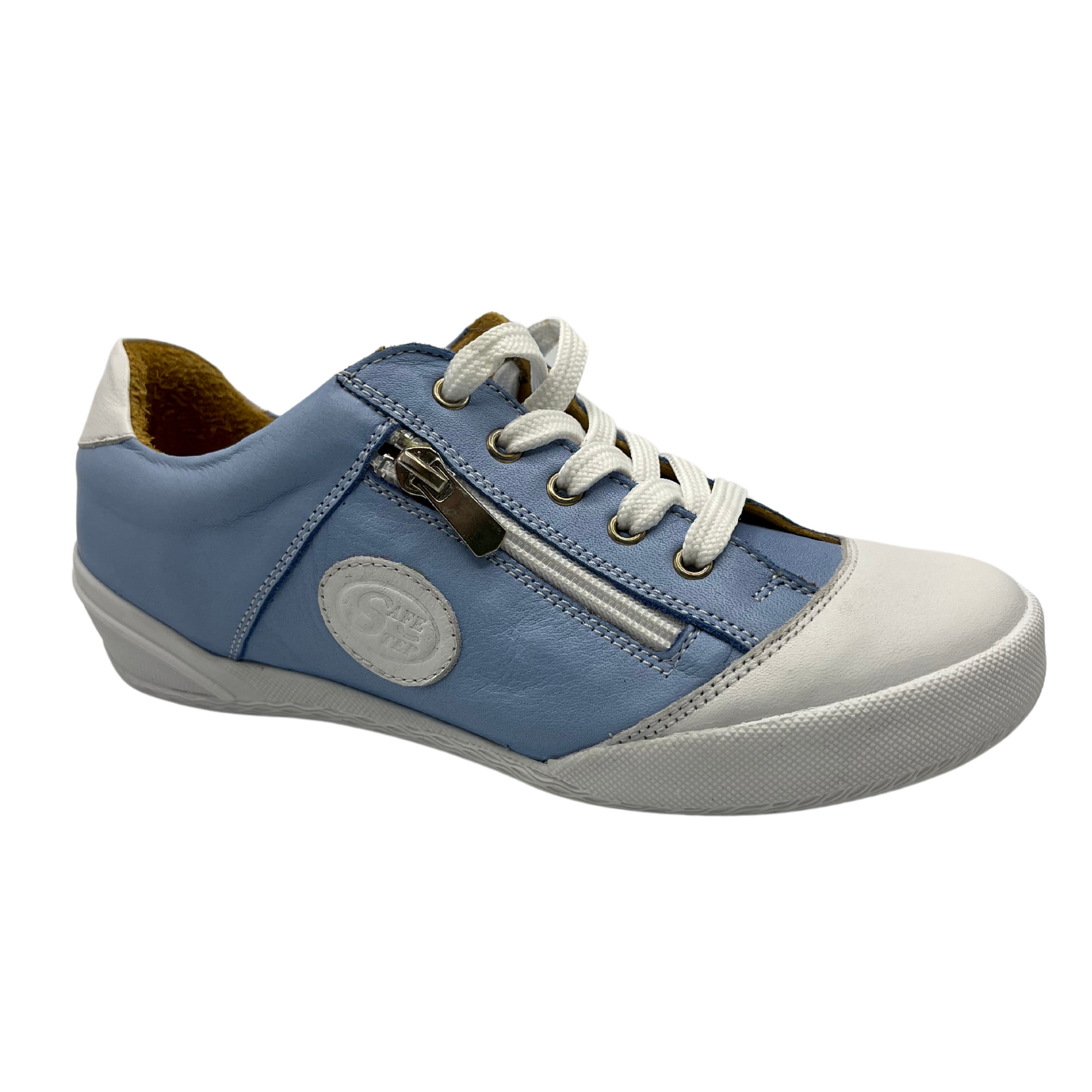 45 degree angled view of blue and white leather sneaker. It has tan leather lining and side zipper along laces. White rubber outsole and white leather toe cap.
