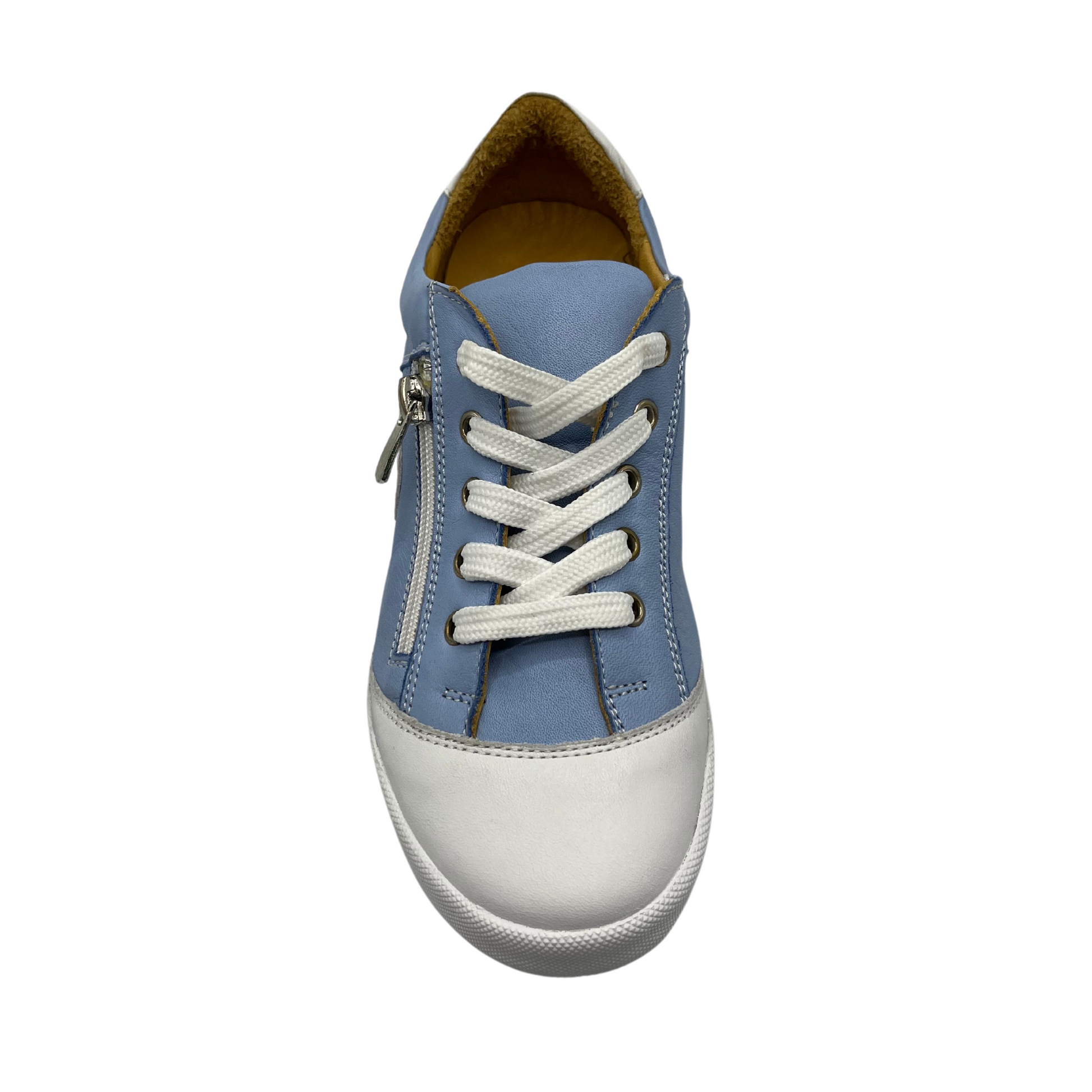Top view of blue and white leather sneaker. It has tan leather lining and side zipper along laces. White rubber outsole and white leather toe cap.