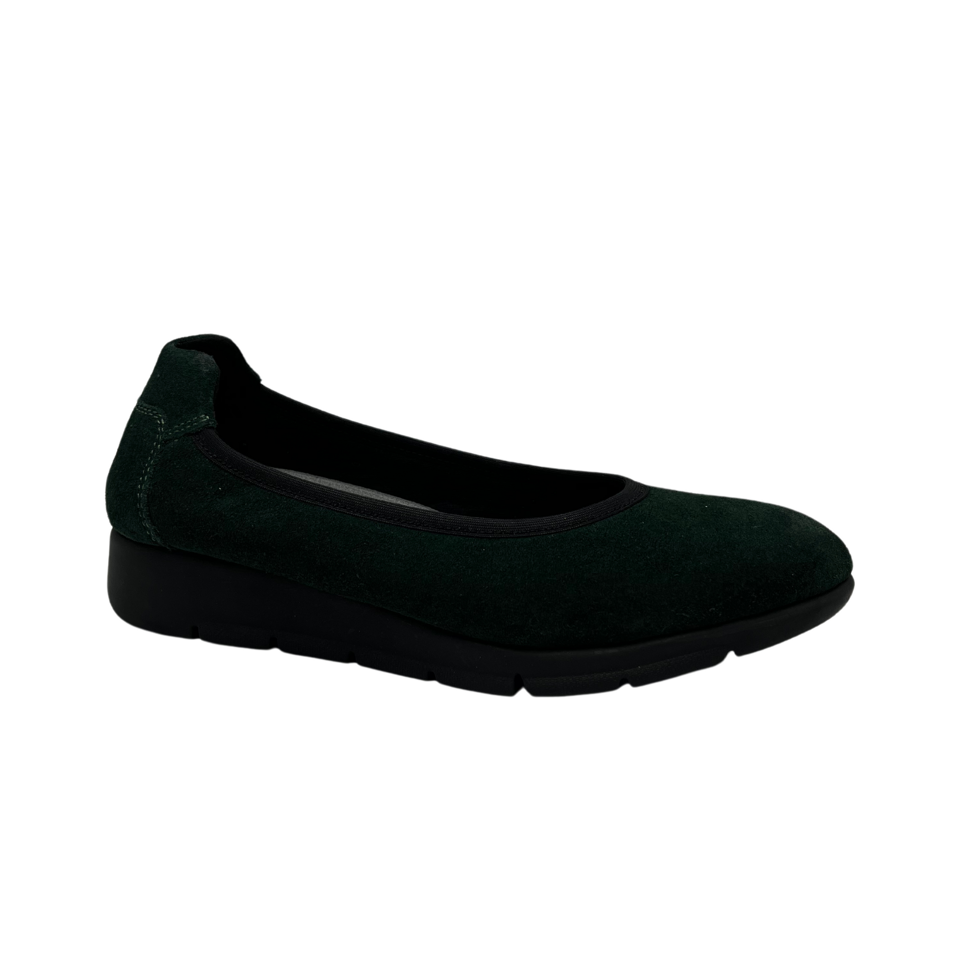 45 degree angled view of green suede low wedge shoe with rounded toe and textile lining