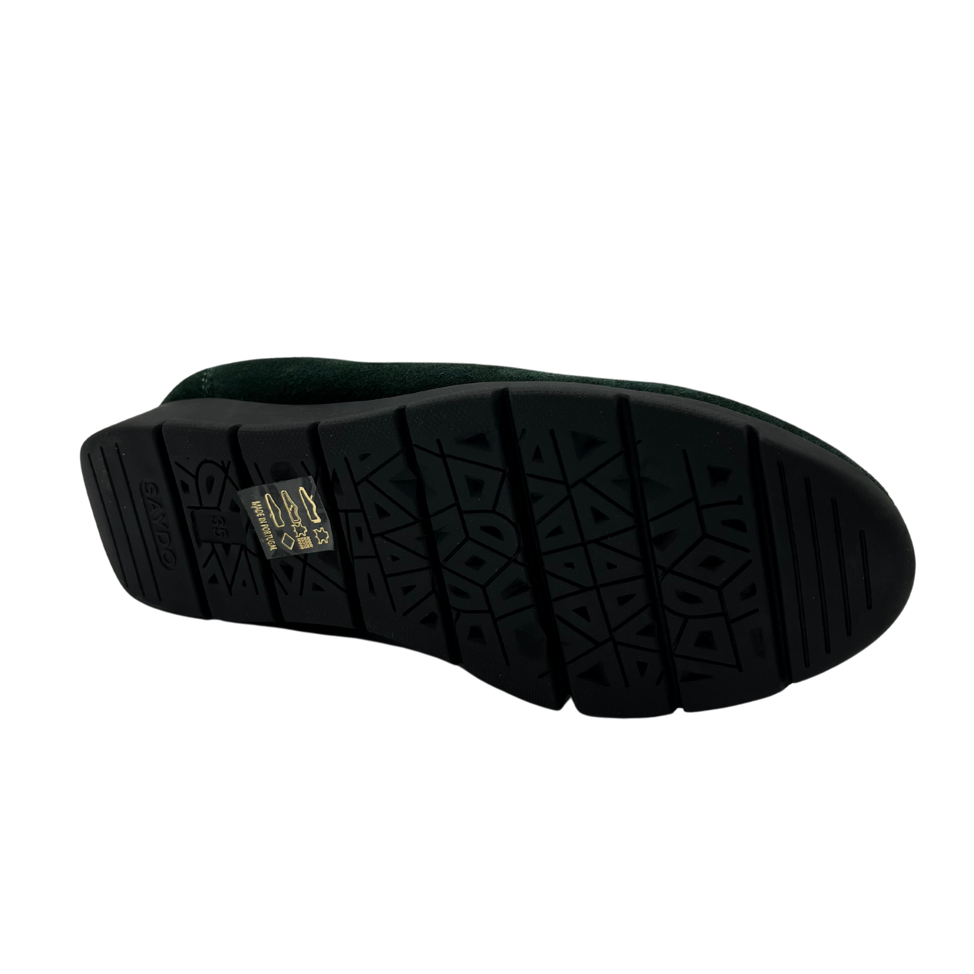 Bottom view of suede green low wedge shoe with rounded toe and black outsole