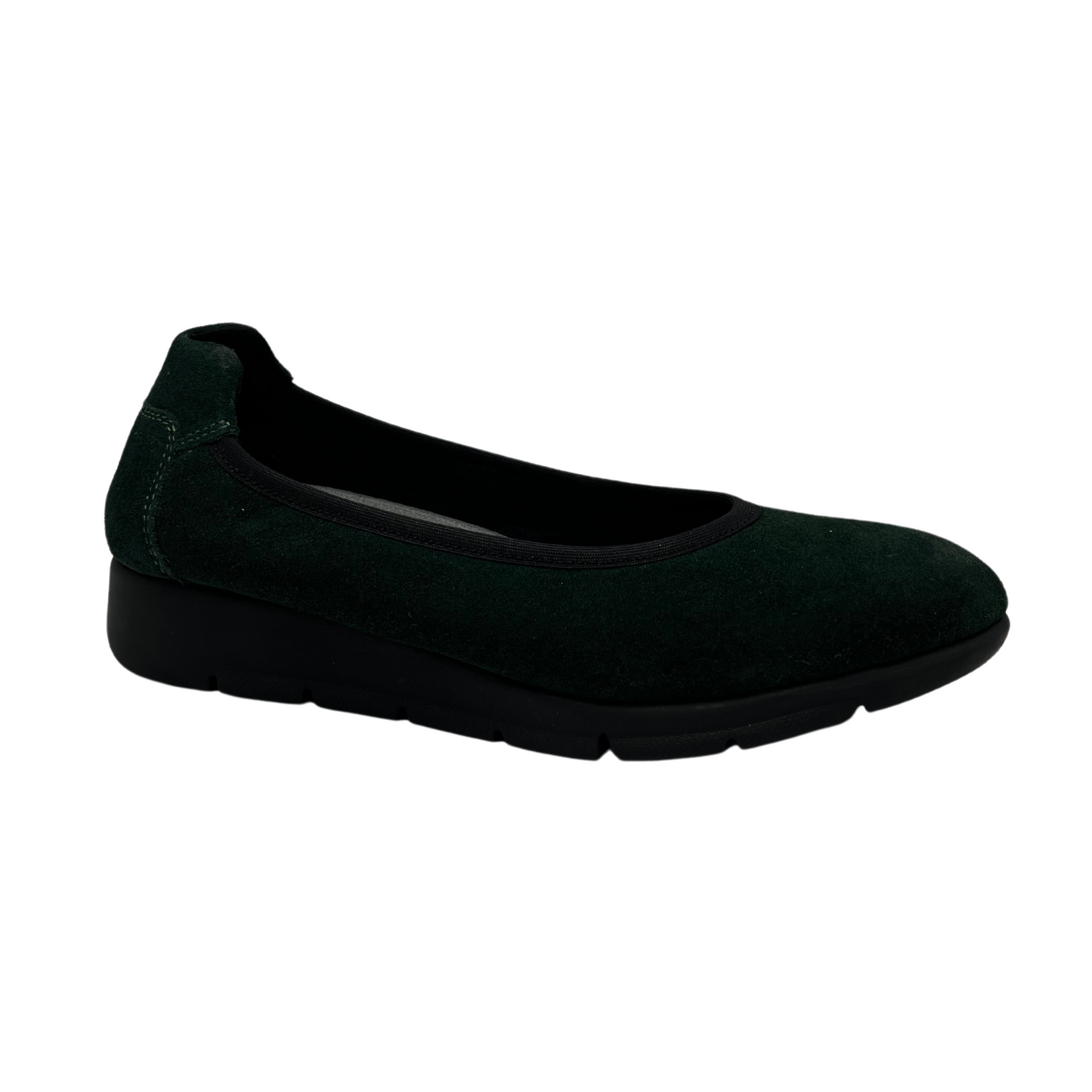 45 degree angled view of green suede low wedge shoe with black outsole and rounded toe