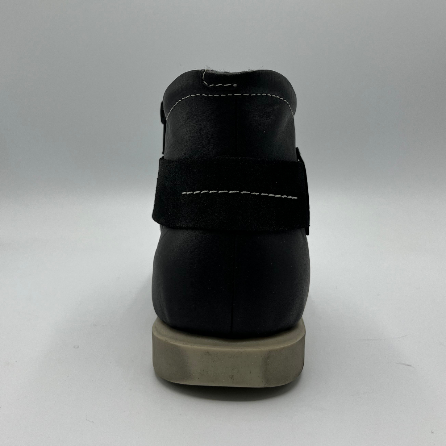 Black shoe with a thick sole on a white background
