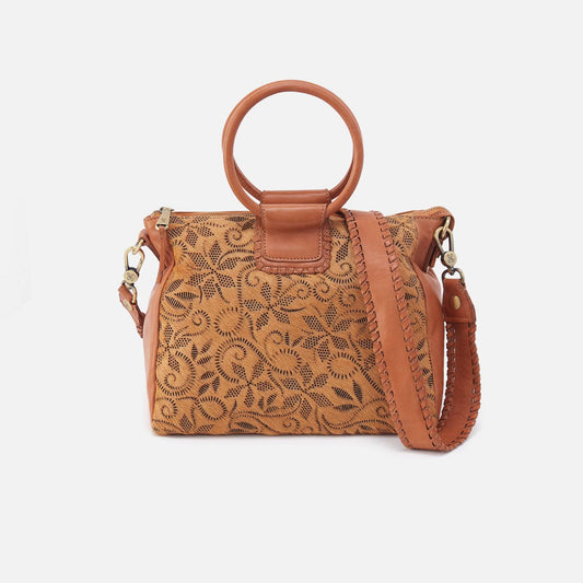 A brown handbag with a floral design