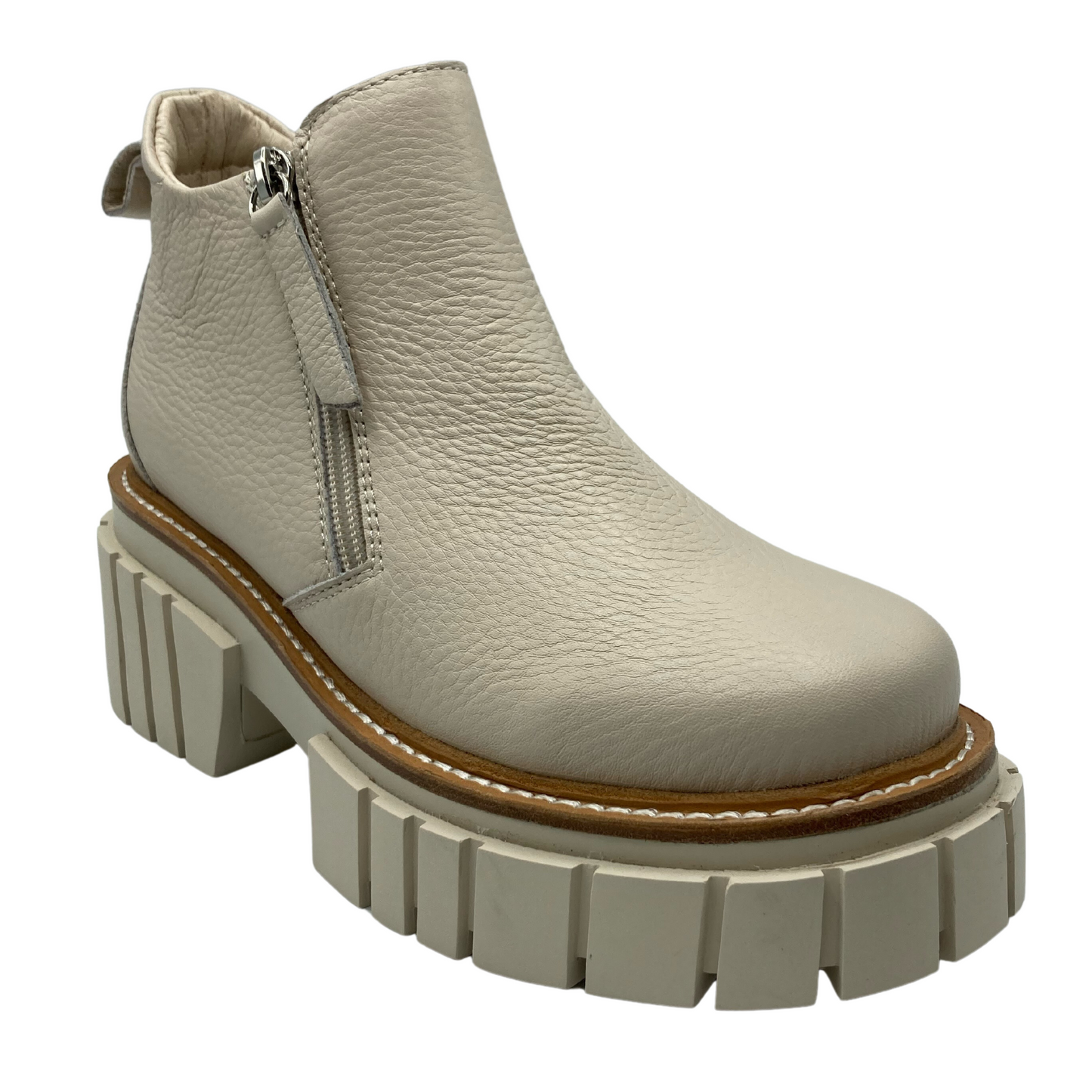 45 degree angled view of bone coloured leather , leather lining and bone rubber outsole