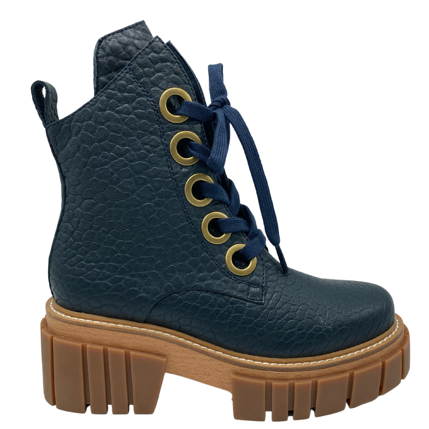 Right facing view of navy textured leather boot with chunky brown rubber outsole and navy laces