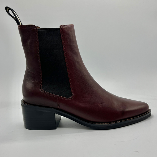 Brown leather boot with a block heel on a white background