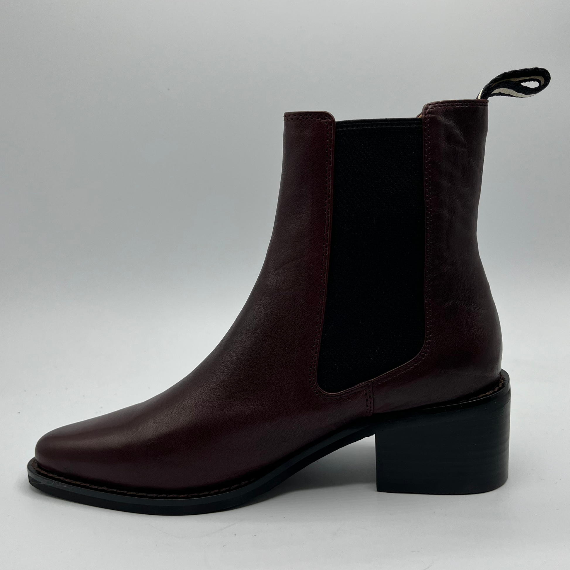 Brown ankle boot on a light gray background