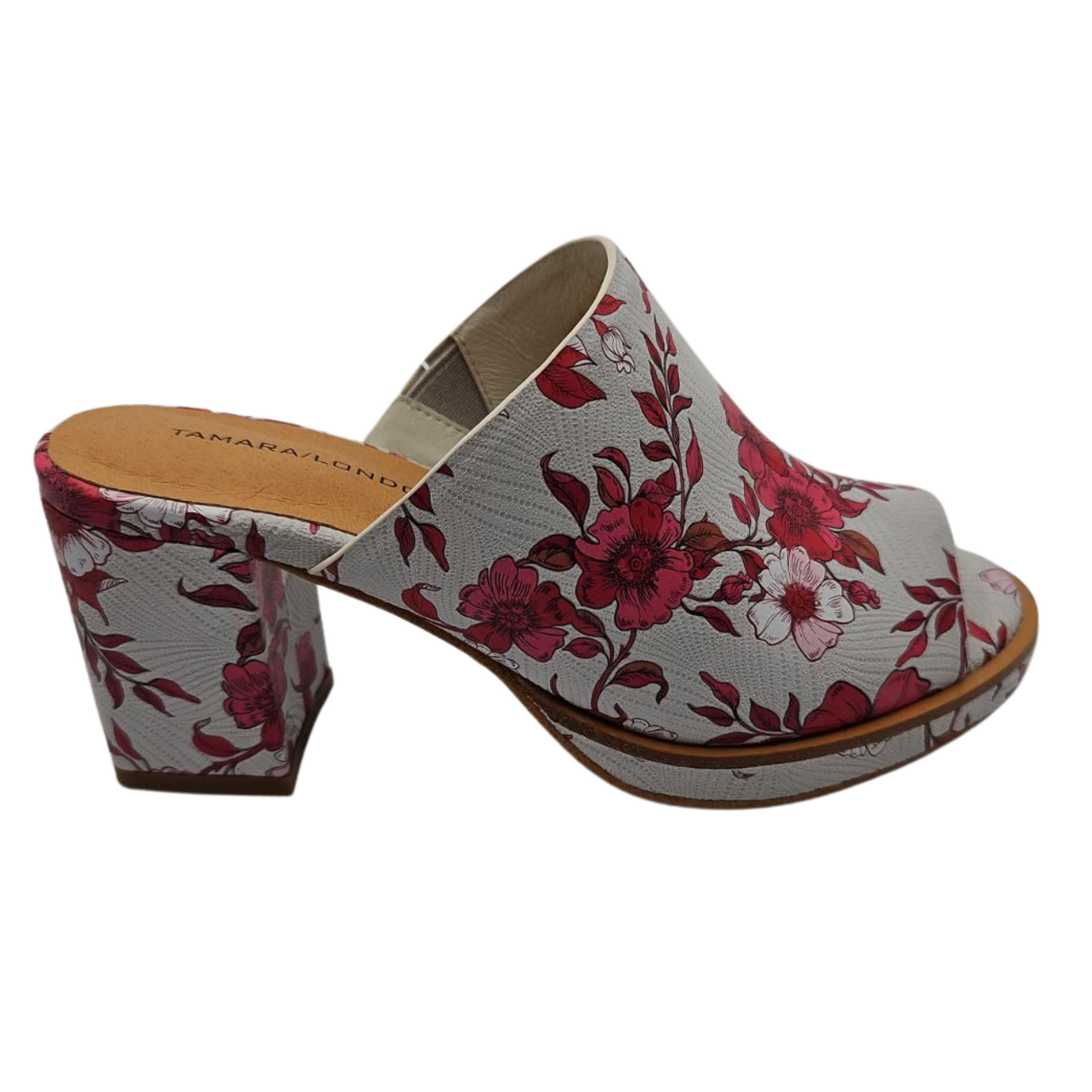 Right facing view of bold floral slip on sandal with wrapped block heel and cushioned footbed.