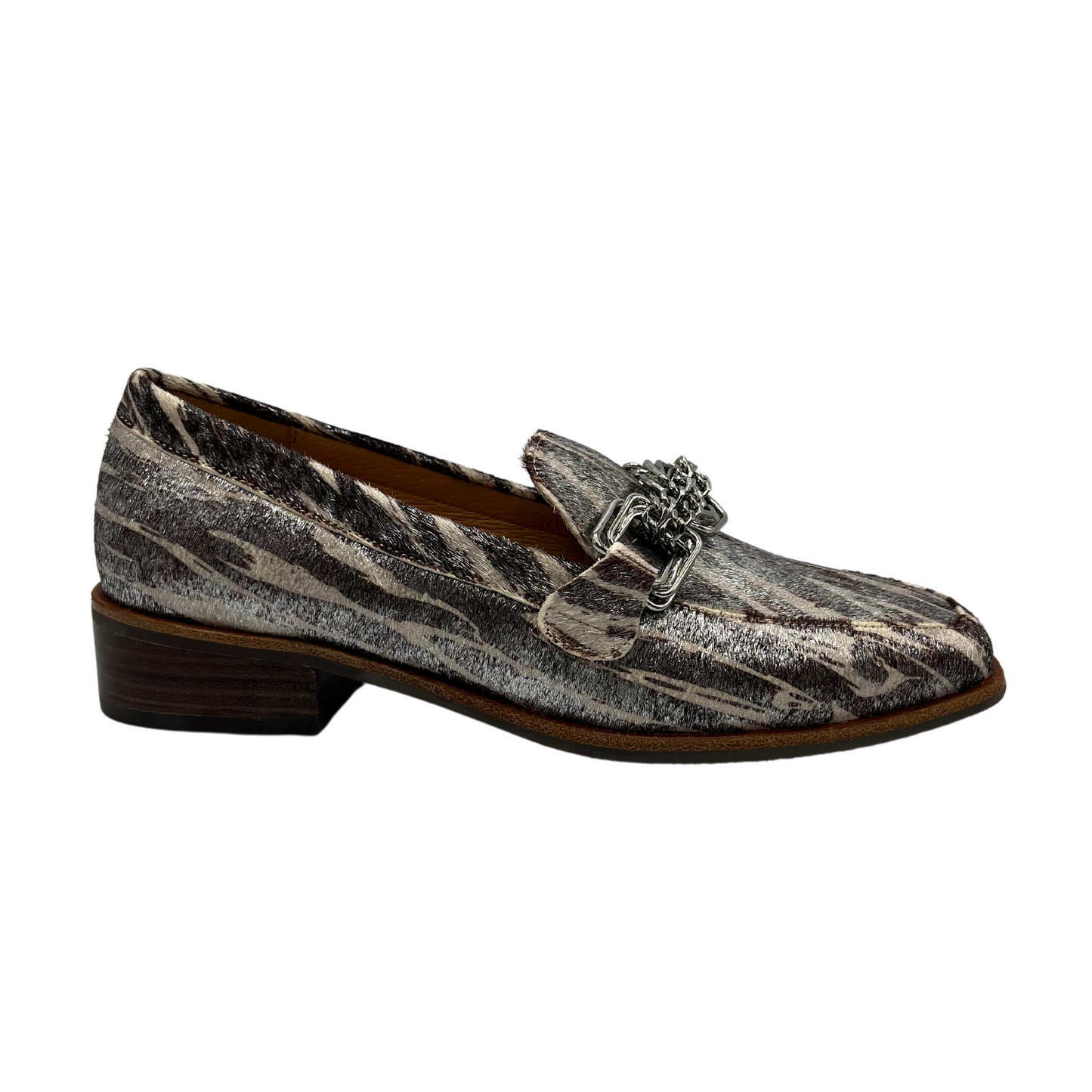 Right facing view of leather loafer with short stacked heel, leather lining and chain detail on upper.