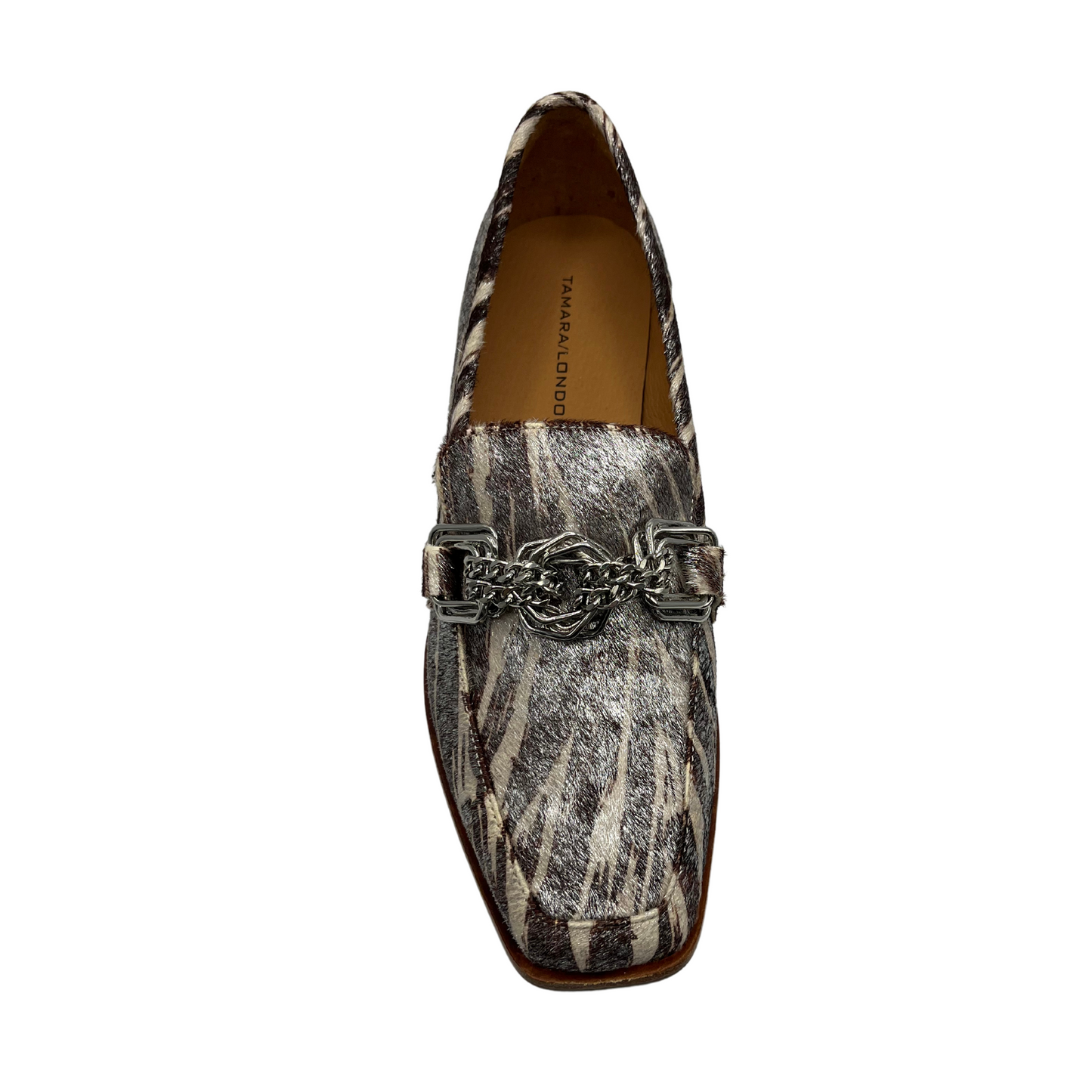Top view of leather loafer with short stacked heel, leather lining and chain detail on upper.
