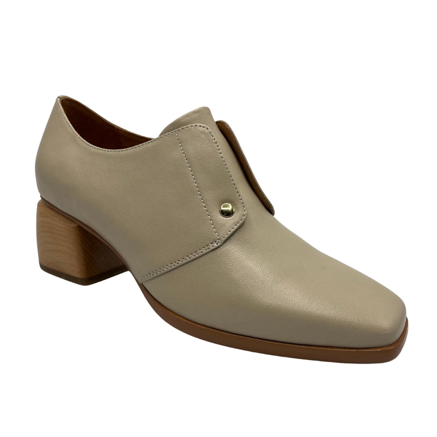 45 degree angled view of nude leather loafer with wood block heel and gold detail.