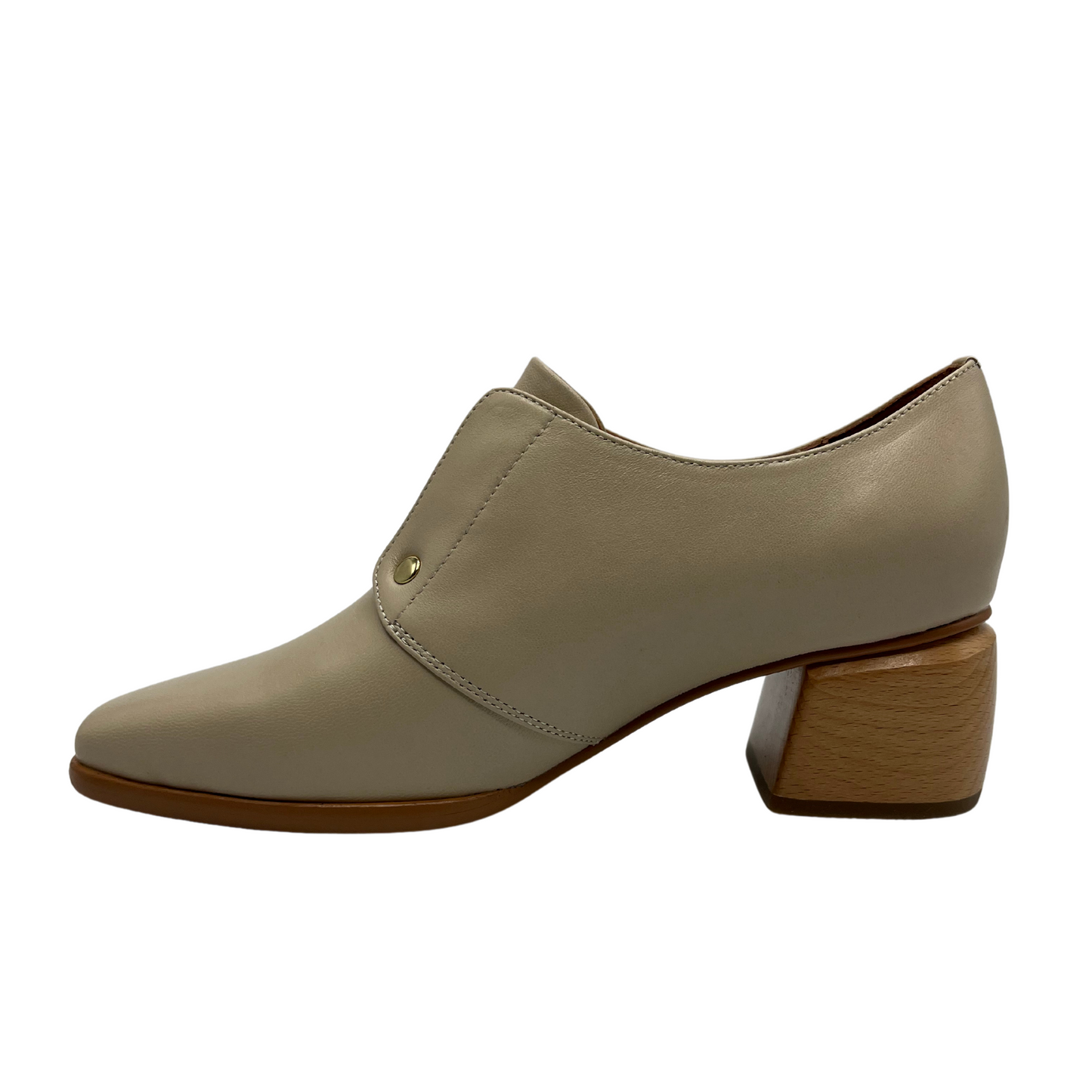 Left facing view of nude leather loafer with wood block heel and gold detail.
