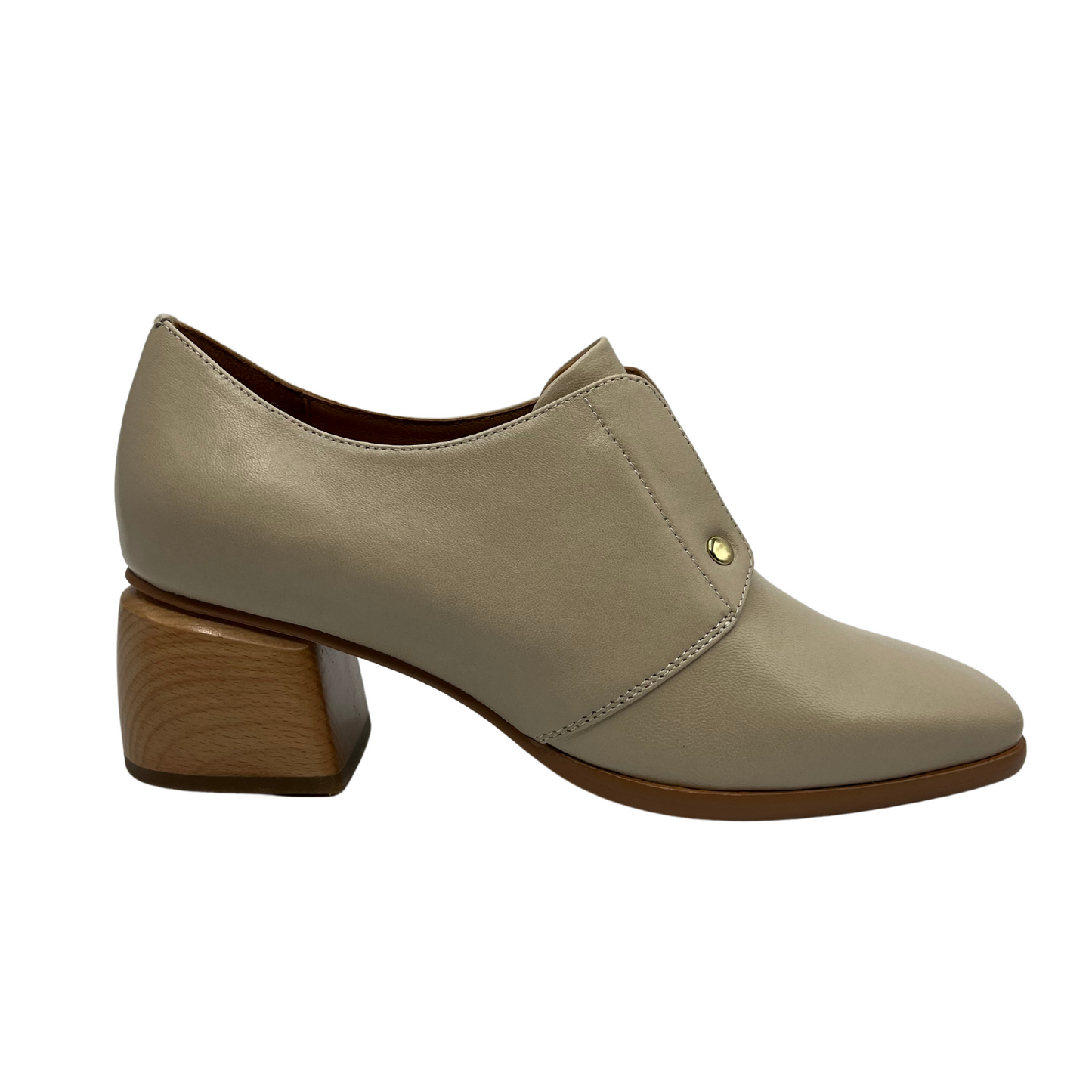 Right facing view of nude leather loafer with wood block heel and gold detail.