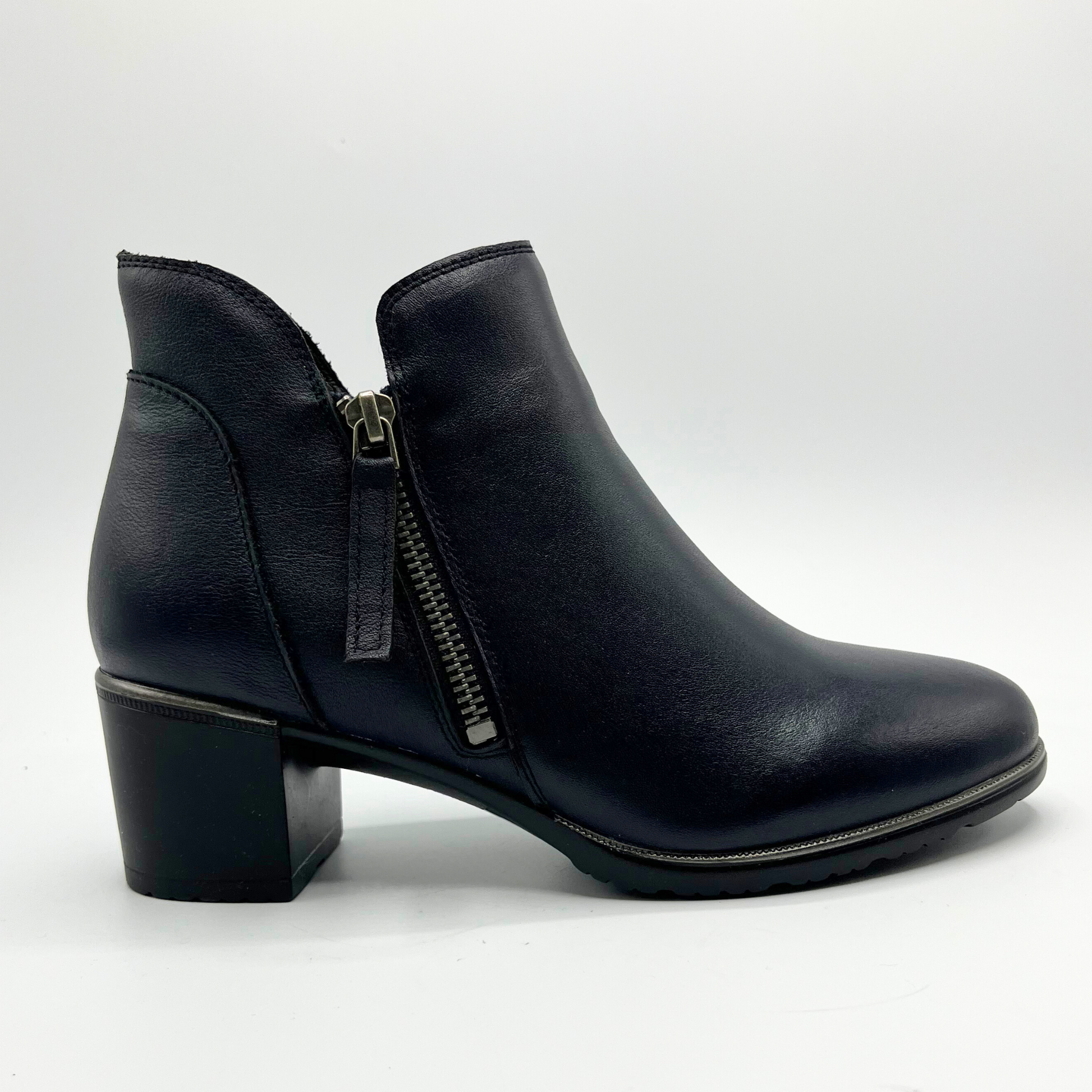 Black leather ankle boot with a zipper on a white background