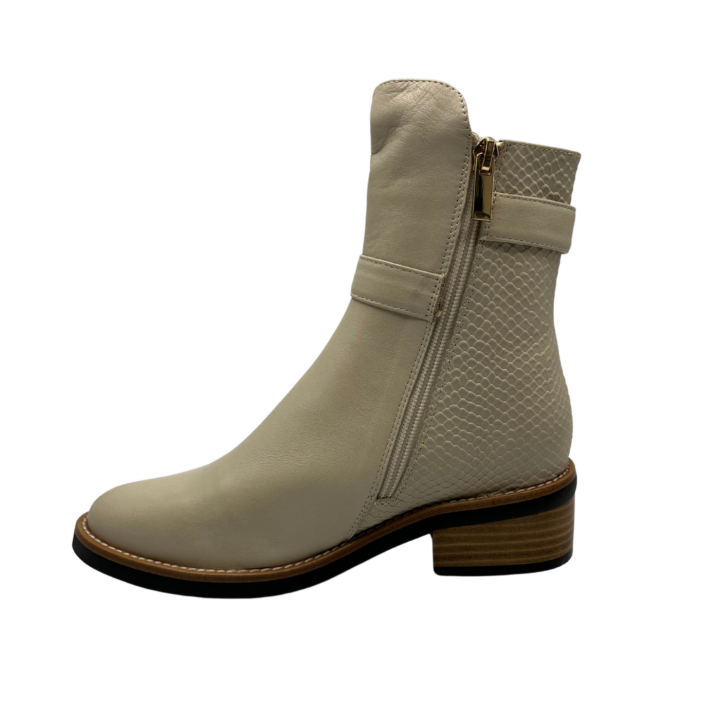 Left facing view of nude short boot with metallic gold accents. Adjustable ankle strap and short block heel.