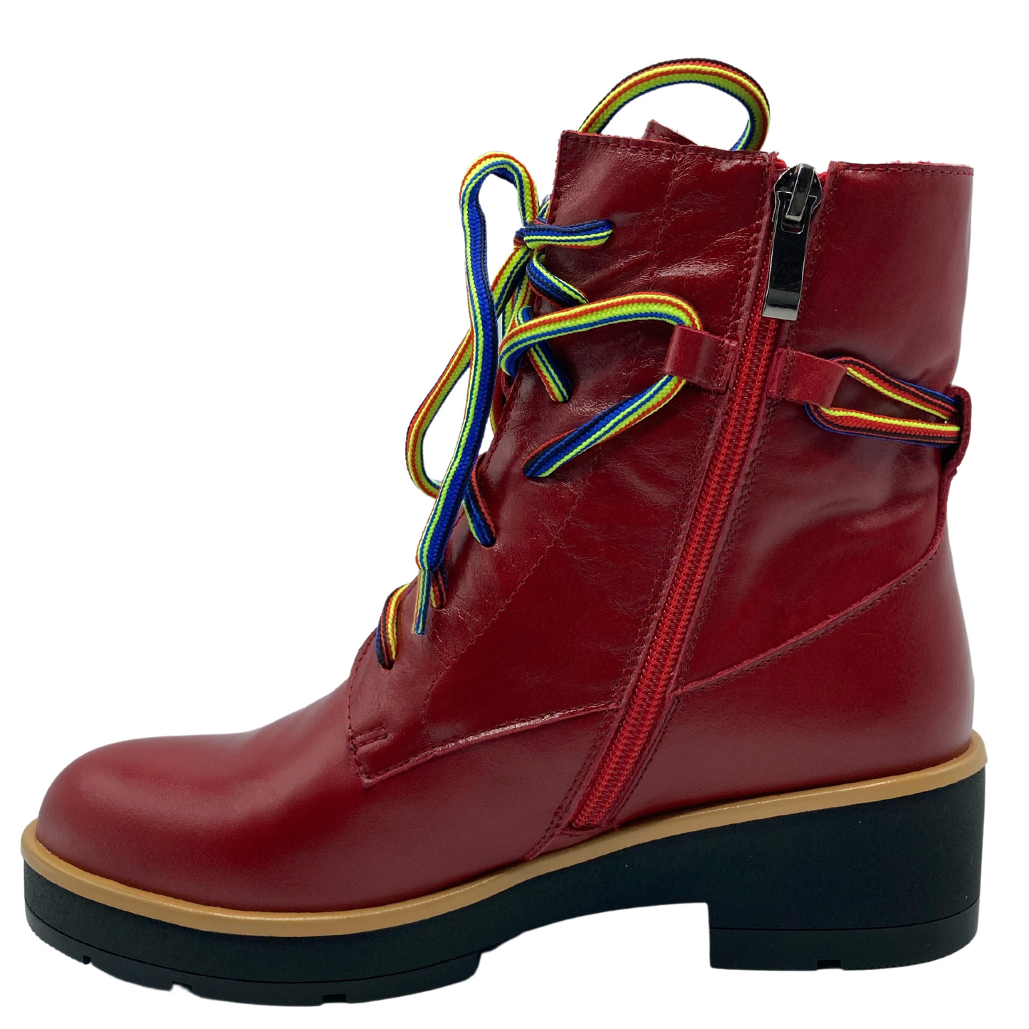 Left facing view of red leather short boot with rainbow laces and side zipper closure. Short heel and black outsole
