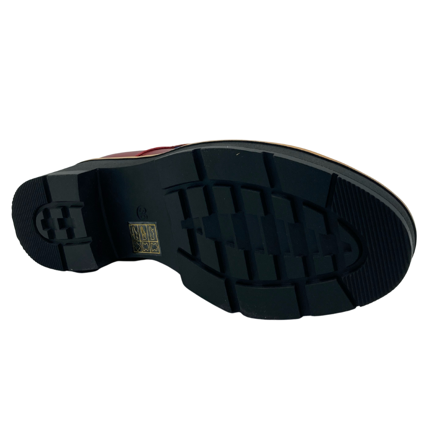 Bottom view of red leather boot with black rubber heel and outsole