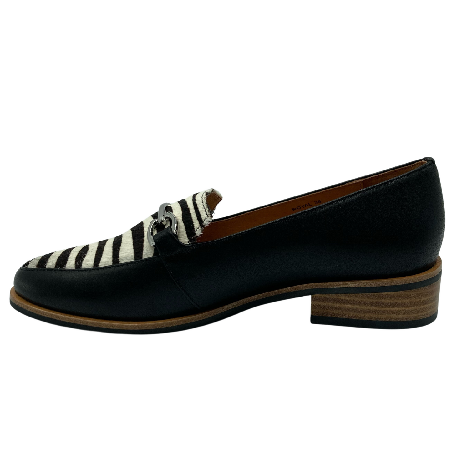 Left facing view of black and zebra print leather loafer with low heel and silver buckle detail on upper