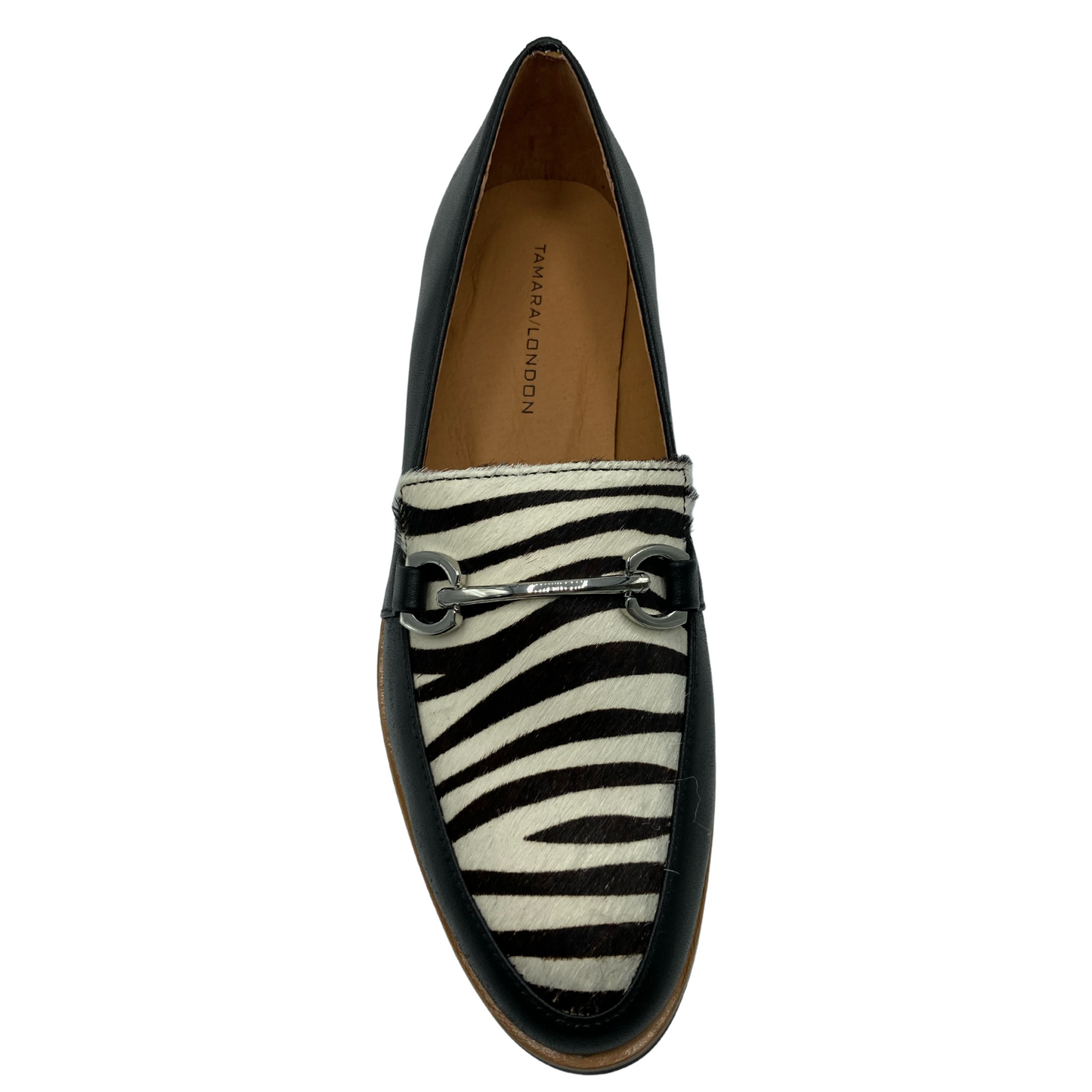 Top view of black and zebra print leather loafer with silver bit detail on upper
