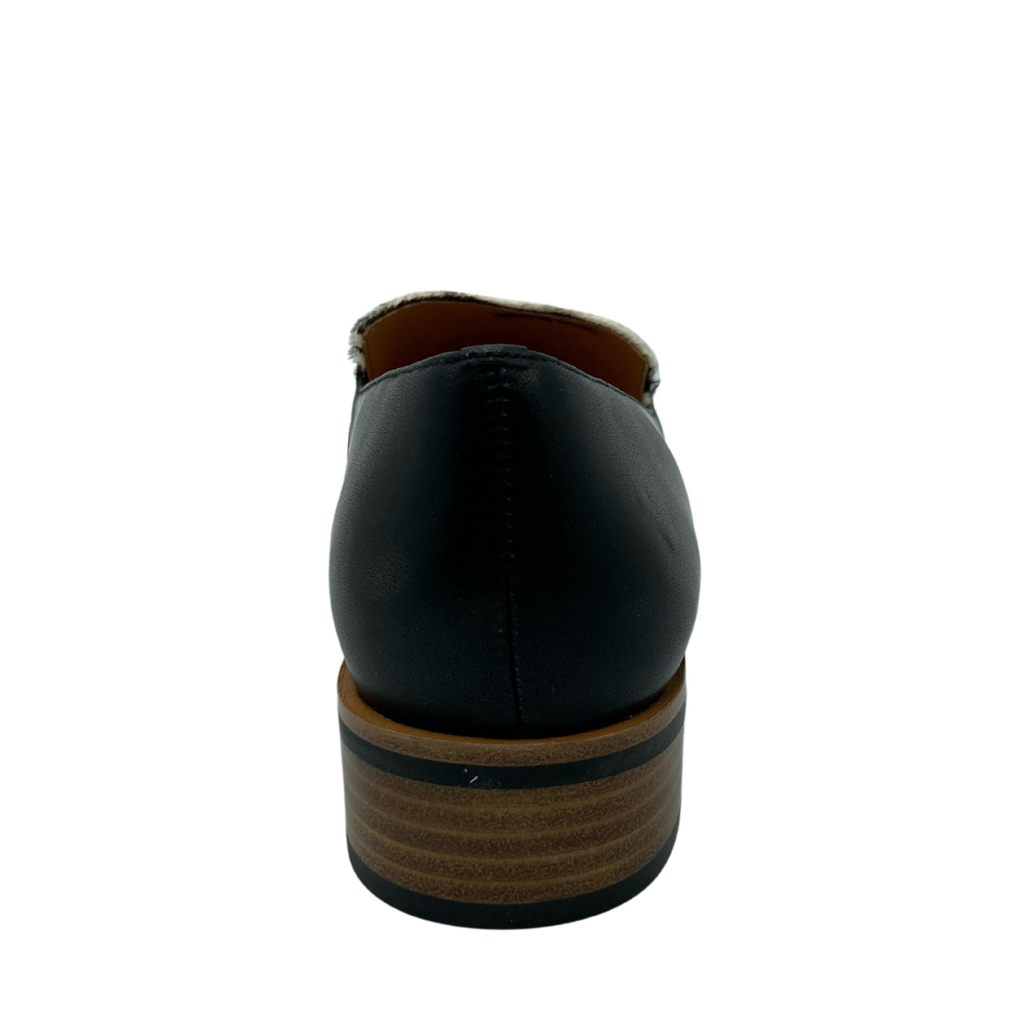 Heel view of a black leather loafer with zebra print and low brown heel