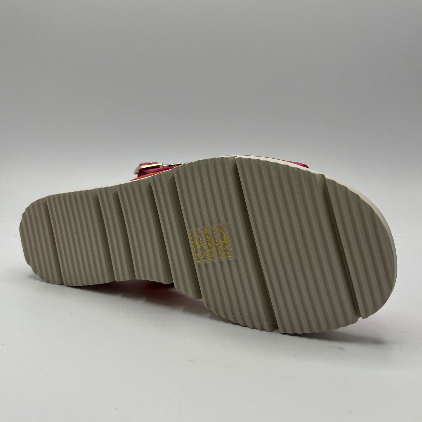 Bottom view of a fuschia and orange leather sandal with a wedge heel, adjustable ankle strap and shiny gold details.