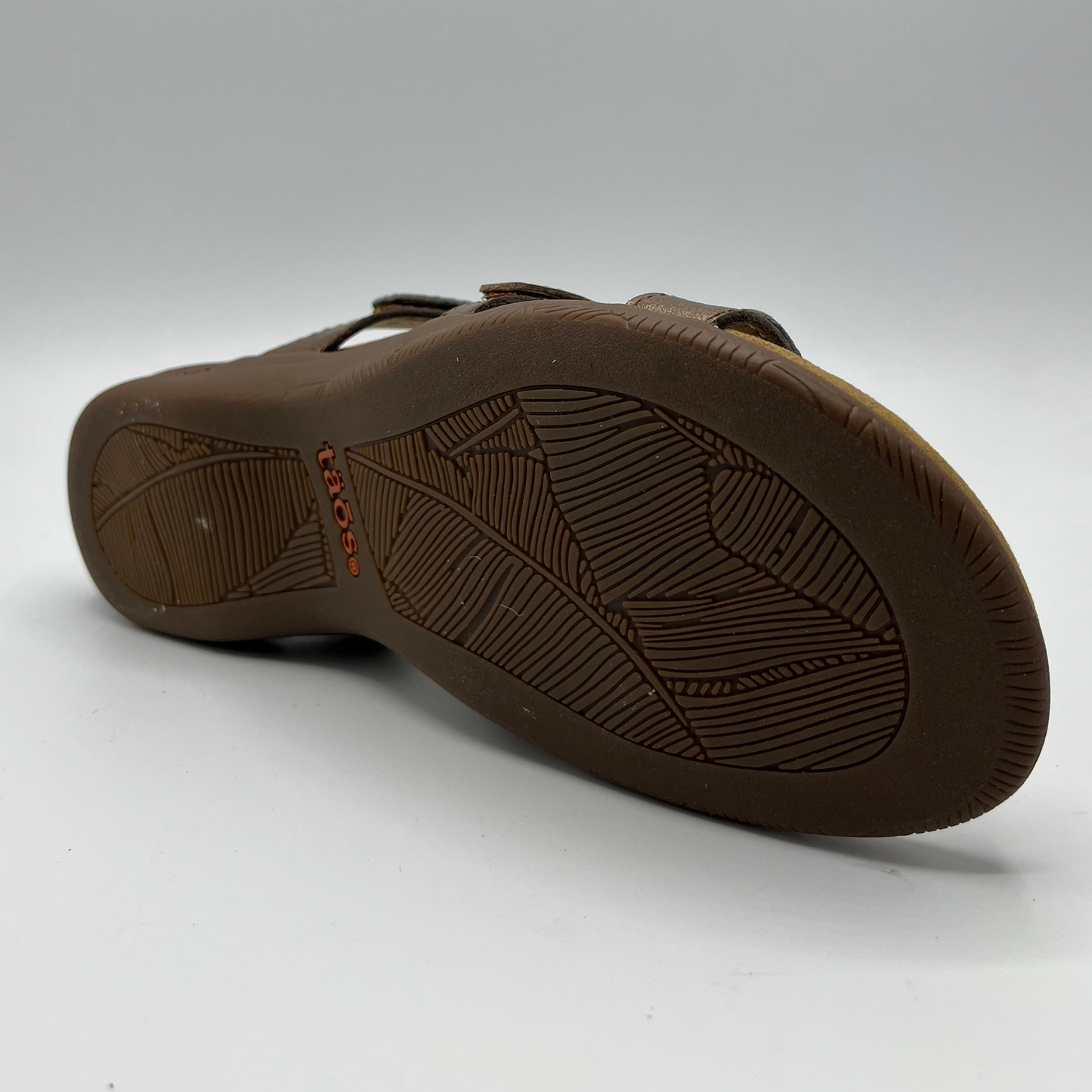 Bottom view of leather sandal with 3 straps and slip on style. Hook and loop closures on straps and lined anatomical footbed