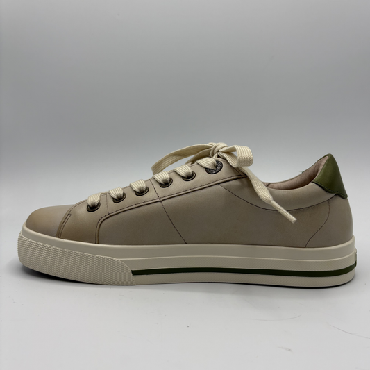 Beige sneaker with white laces on a gray background