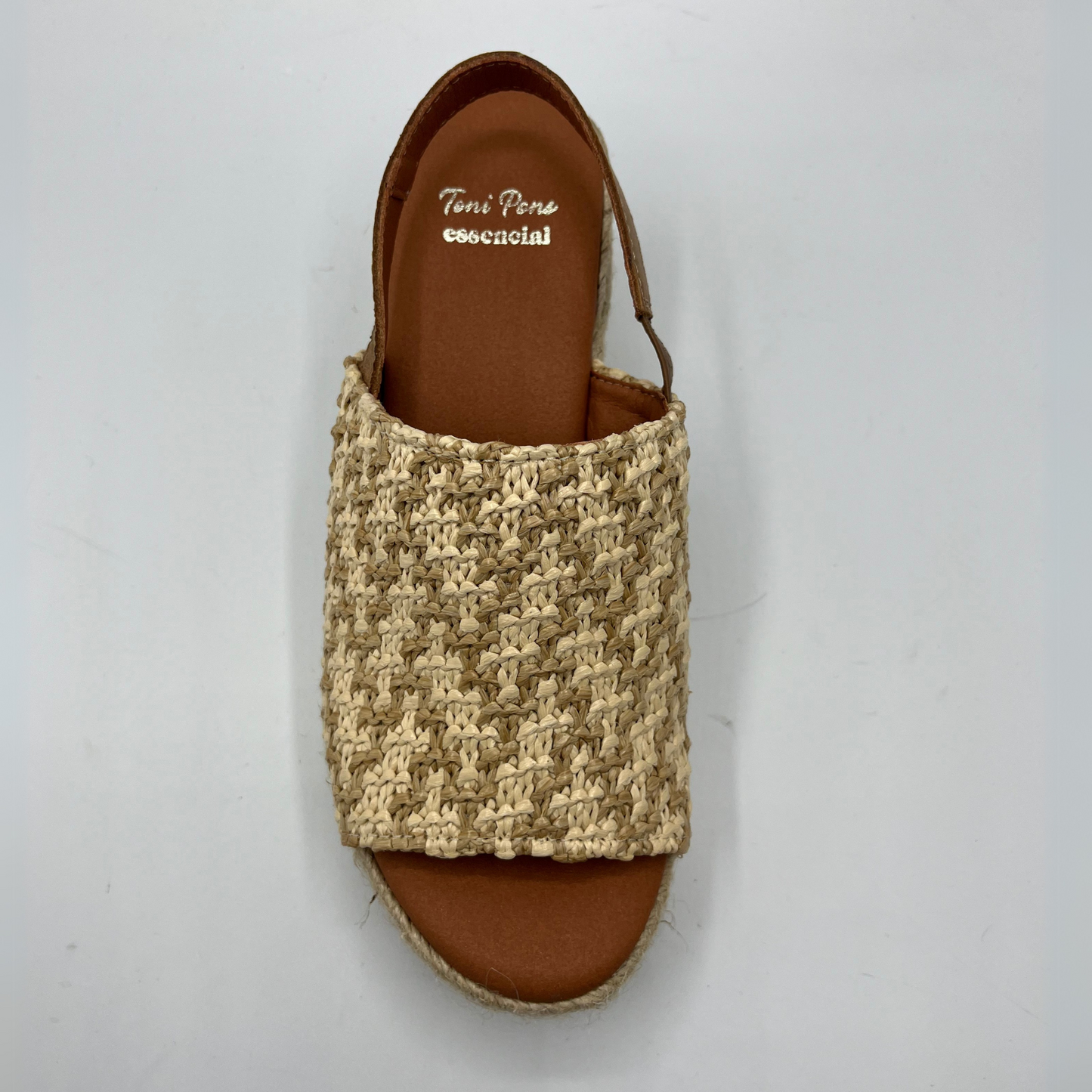 Top view of a chunky wedge heel with an elasticated slingback strap and peep toe.