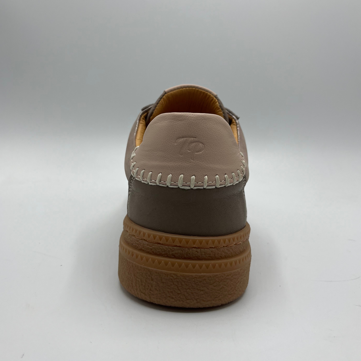 Brown shoe with a visible brand logo on a white background