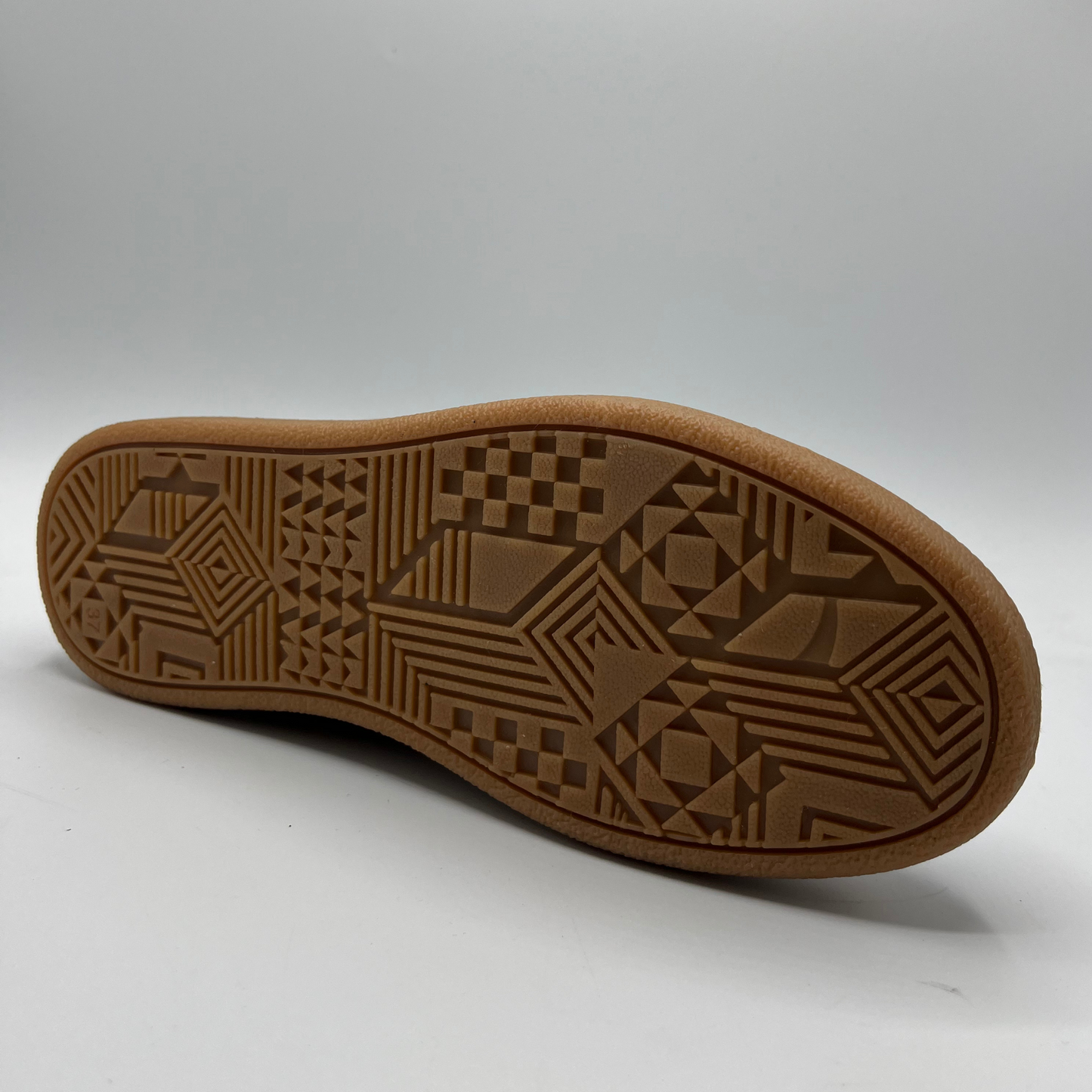 Brown shoe sole with geometric pattern on a white background
