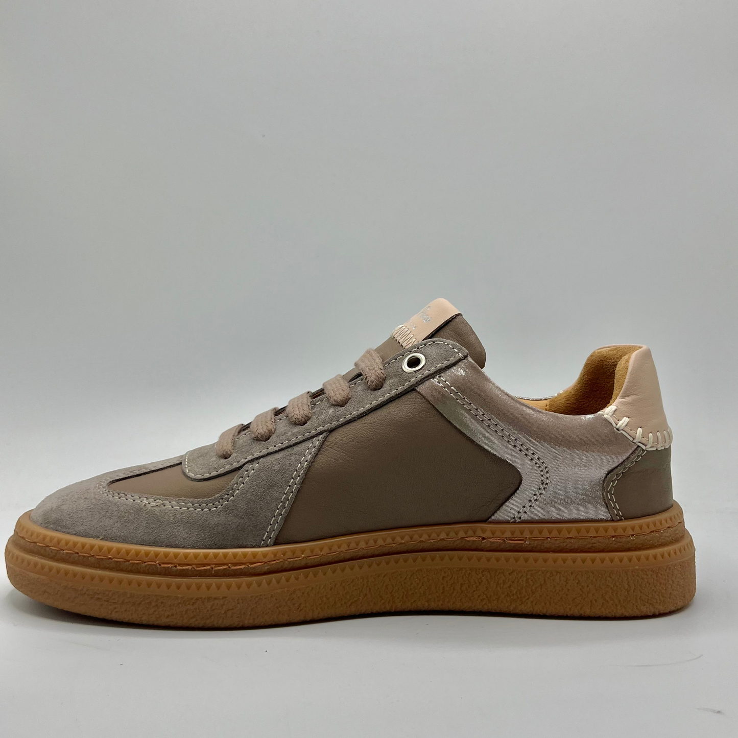 Brown and beige sneaker on a gray background