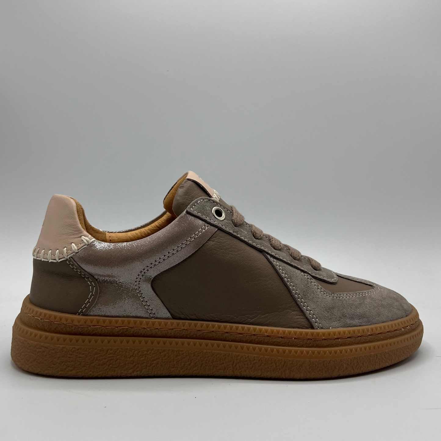 Brown and beige sneaker on a gray background