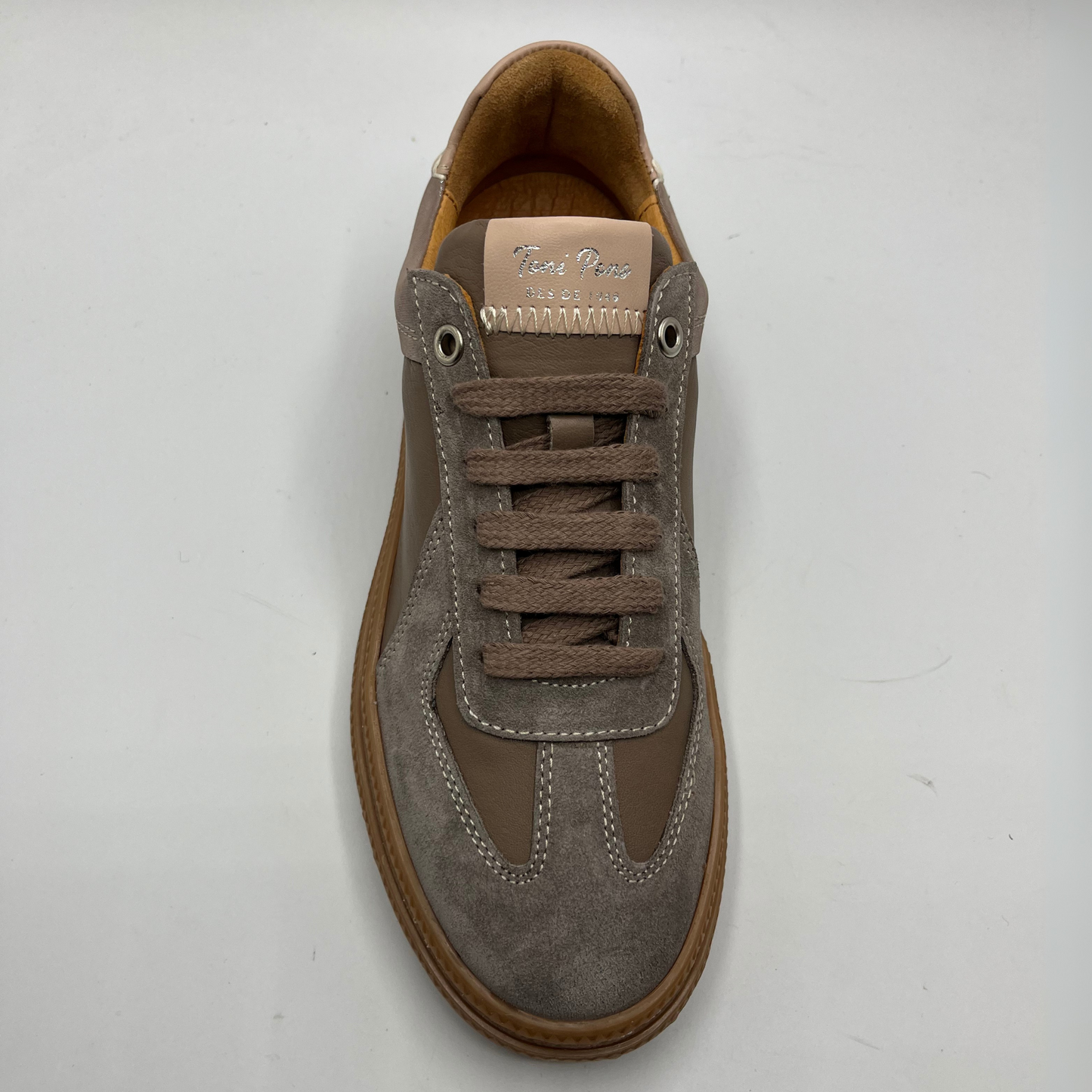 Brown suede sneaker on a white background