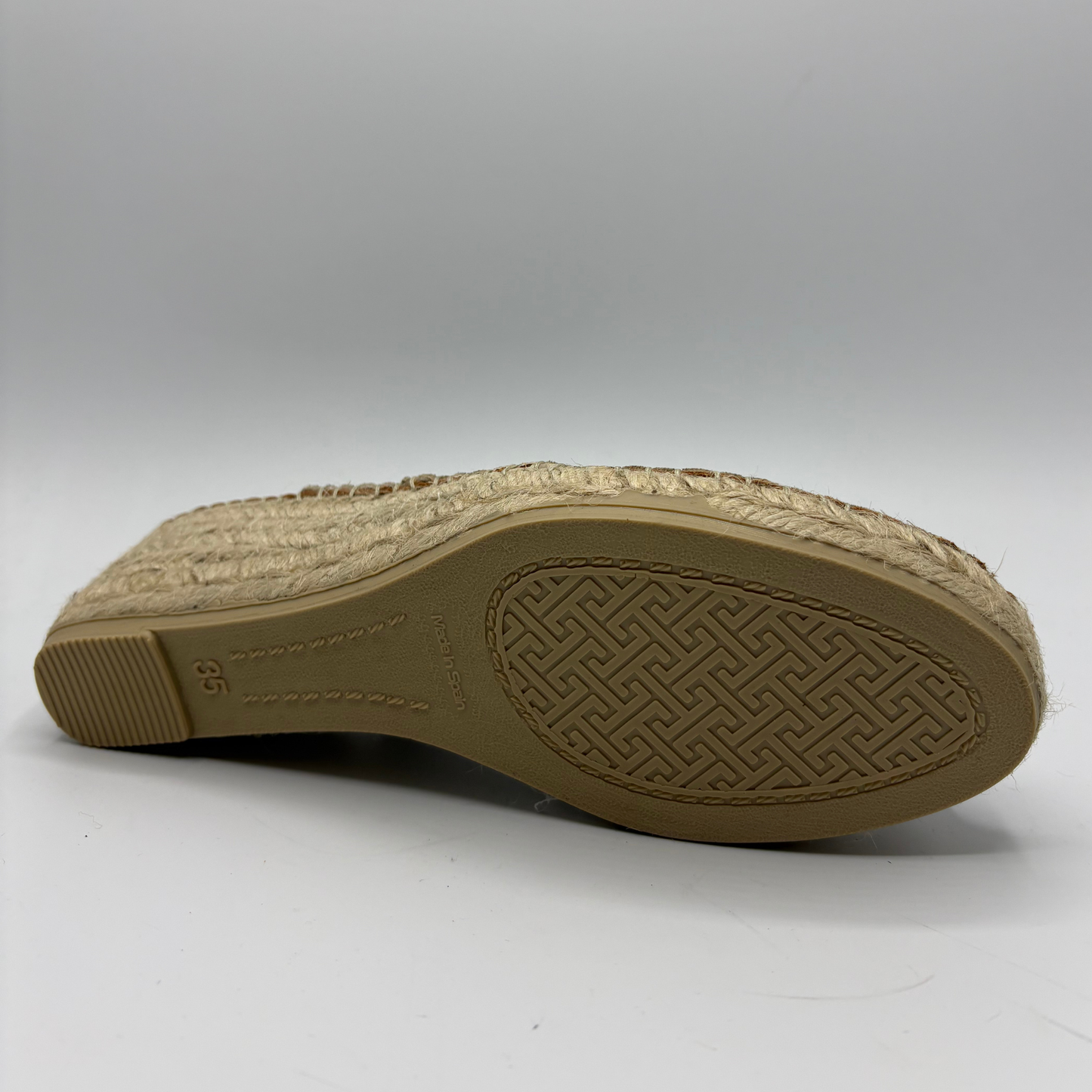 Brown shoe sole with textured pattern on a white background