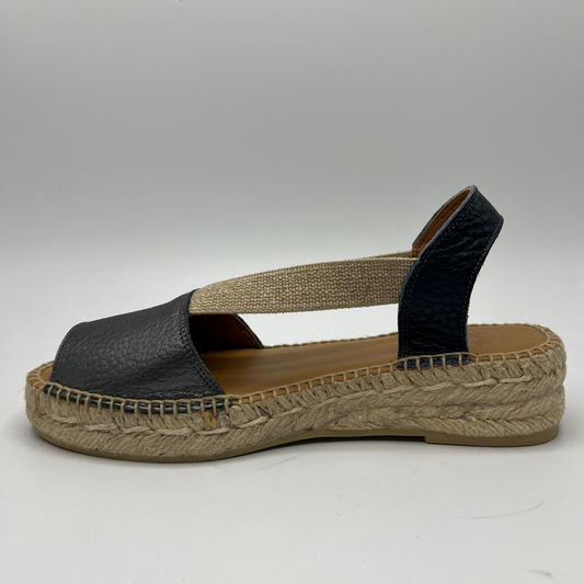 Left facing view of an espadrille soled sandal with elasticated side straps and platinum leather straps.