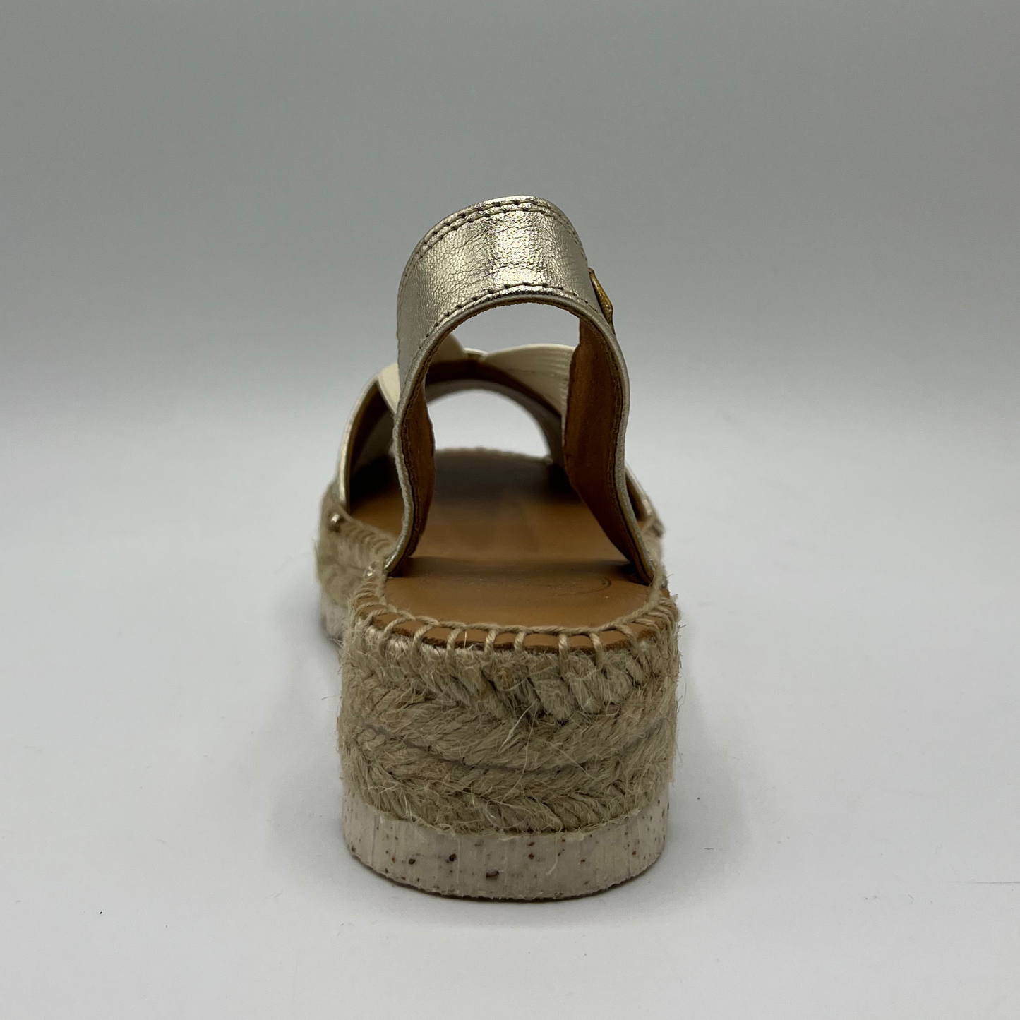 Back view of an espadrille soled sandal with elasticated side straps and platinum leather straps.