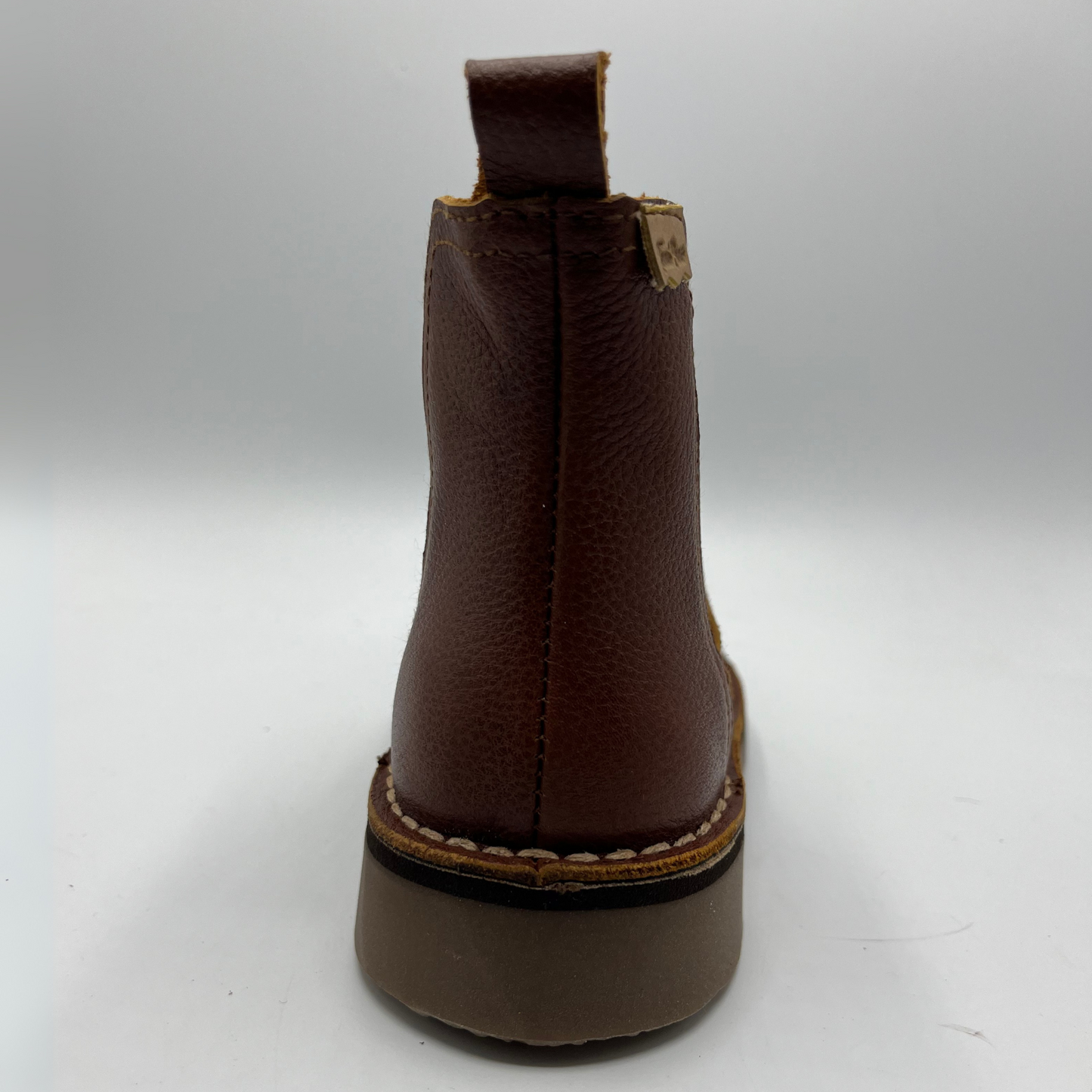Brown leather boot on a white background