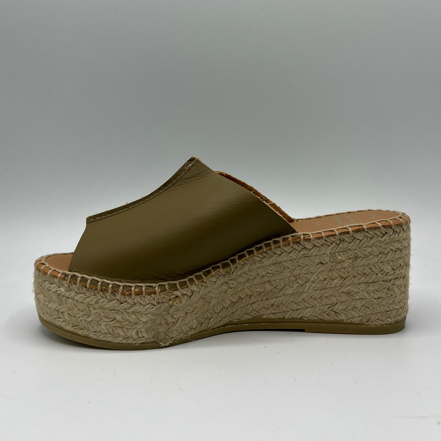 Left facing view of a khaki leather espadrille sandal with wedge heel and stitching round sole