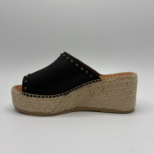 Black wedge sandal with jute sole on a gray background